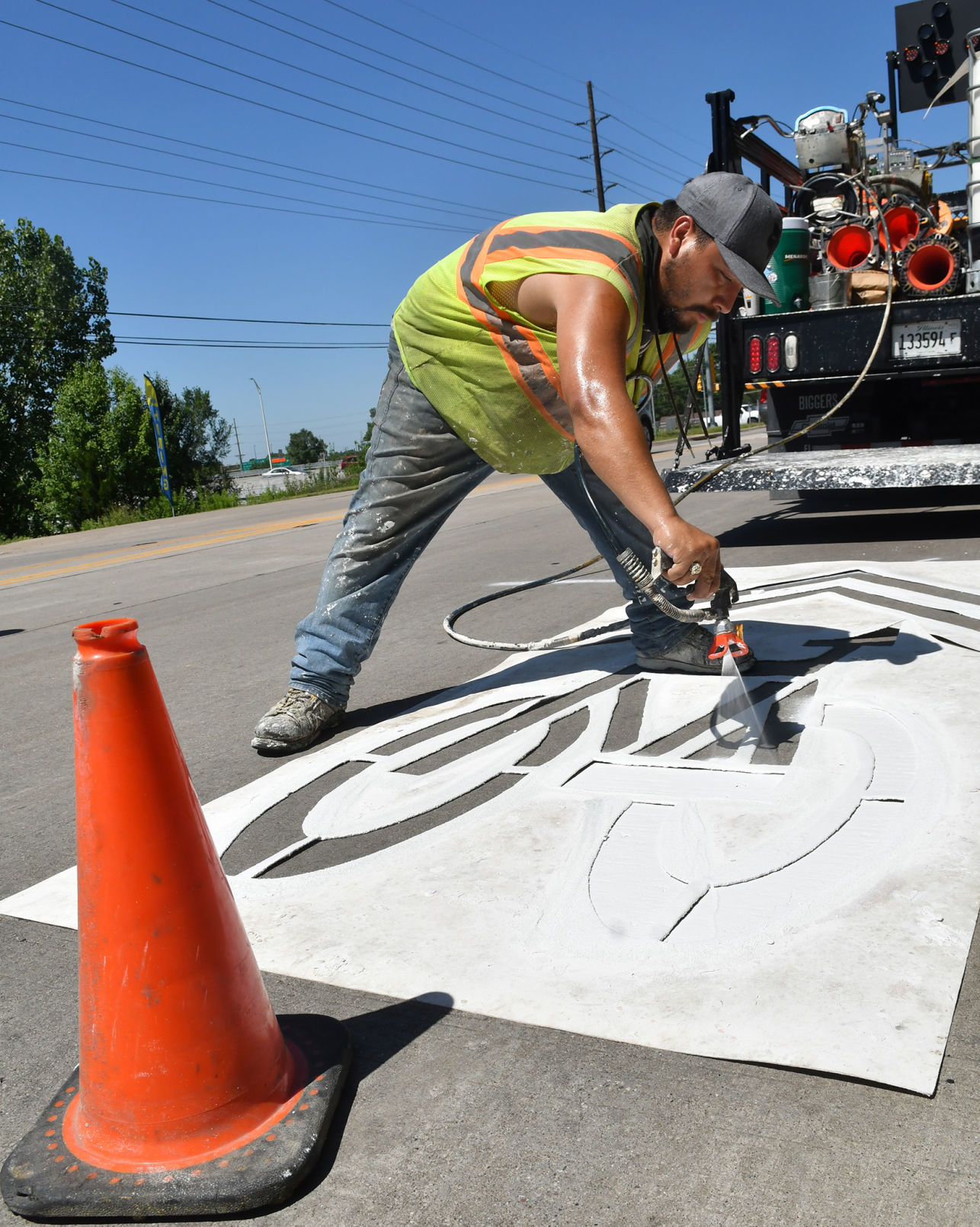 Painting of sharrows for bike lanes in Moline.